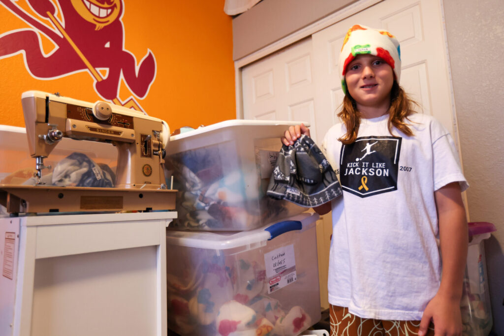 Cody Jack has storage boxes of beanies and materials for his business, which is currently based out of his bedroom. 