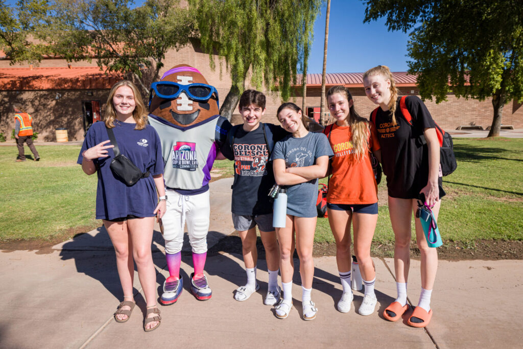 Posed photo of group helping to plant trees at Corona del Sol High School