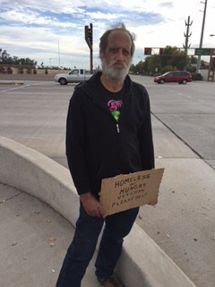 A homeless man seen asking for spare change near Warner Road and the Loop 101. 