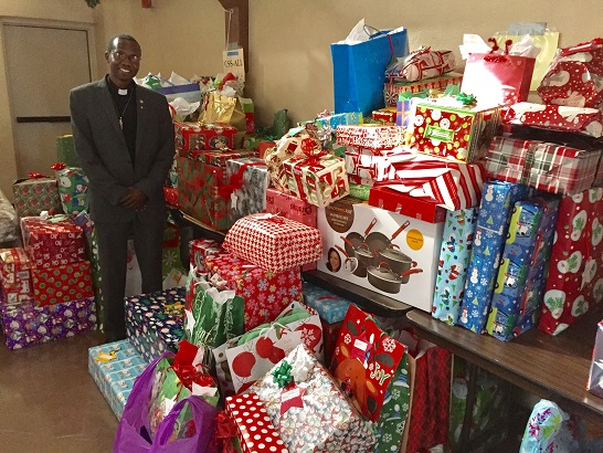 Rev. Robert Aliunzi, A.J., said parishioners have been generous in supplying gifts for the annual Giving Tree project at St. Andrew's. (Wrangler News photo by Joyce Coronel)
