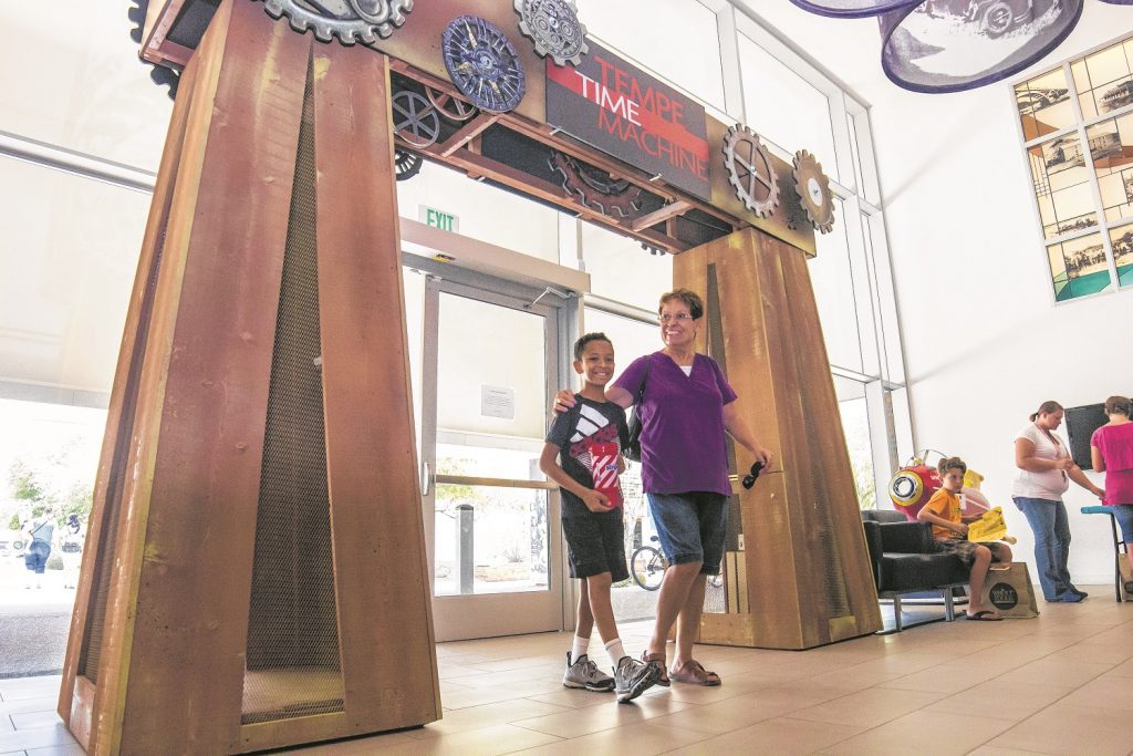 GRAND ENTRANCE - -Josie Lagunas with grandson Adarius Gammage passes through the portals of a 'Time Machine' that opens doors to the Valley's past.  (Wrangler News photo by Alex J. Walker)